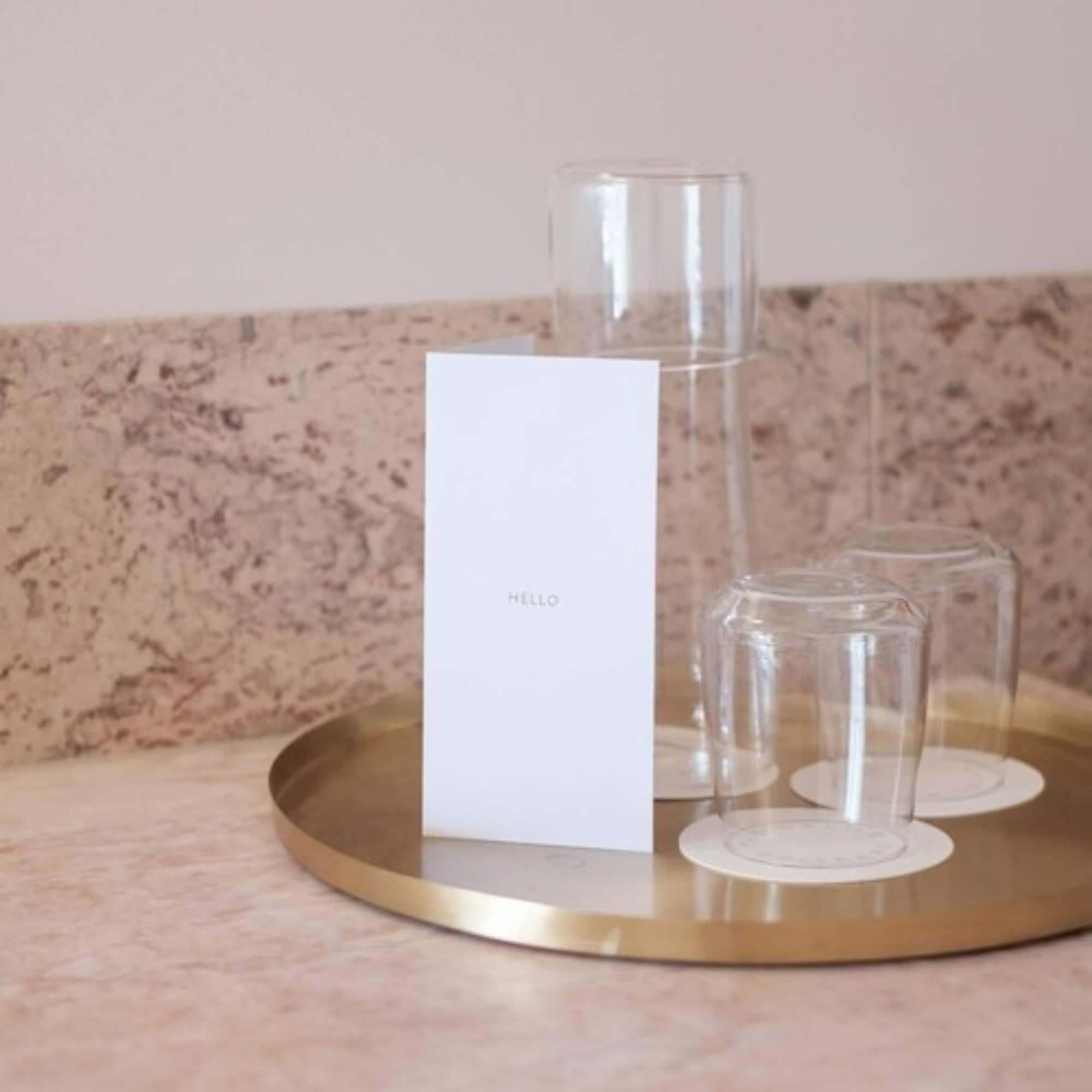 The Calile Hotel Brisbane Bagian luar foto A tray of water and glasses at a hotel